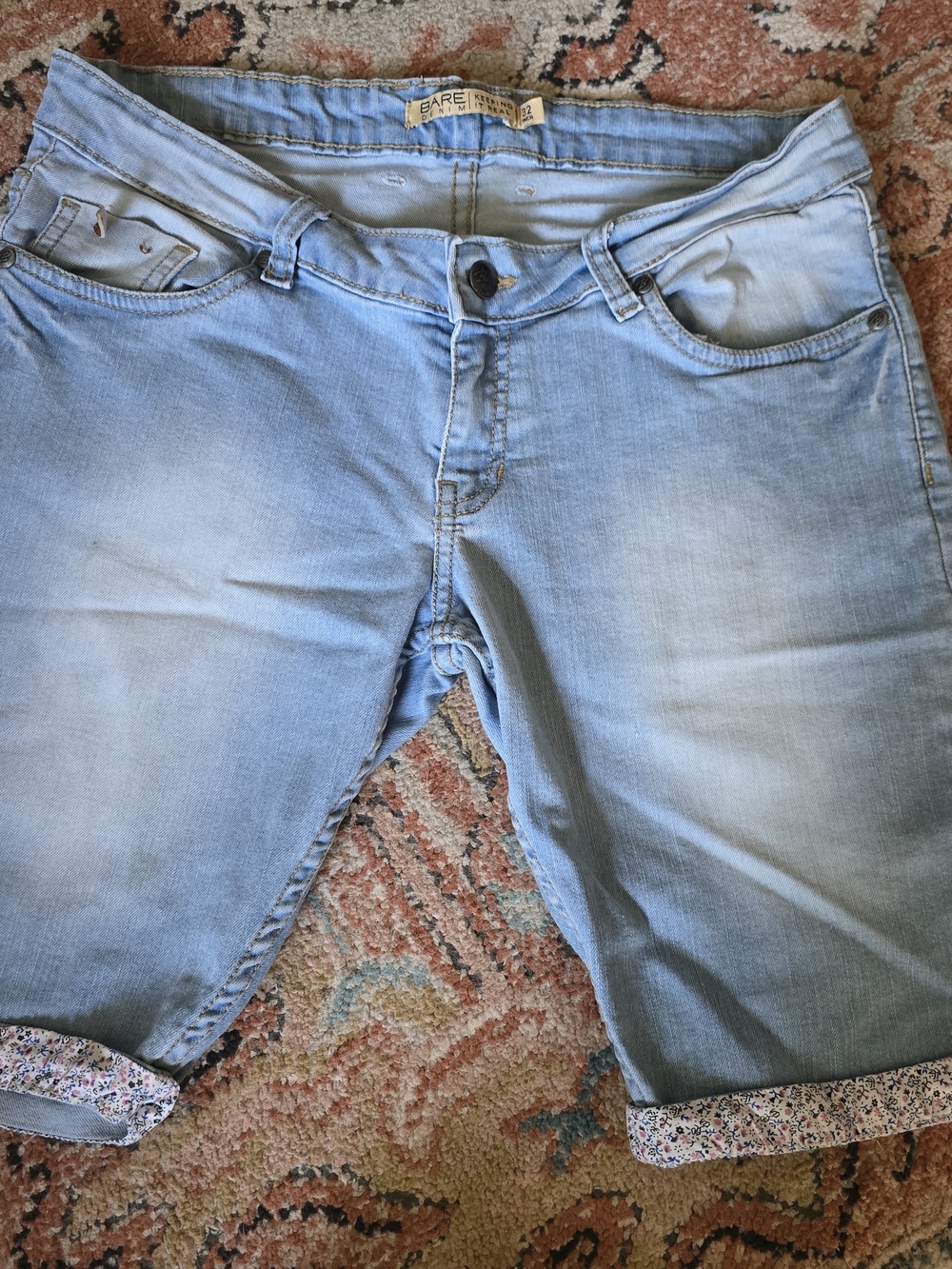 light-wash denim Bermuda shorts from Bare feature distinctive floral print cuffs